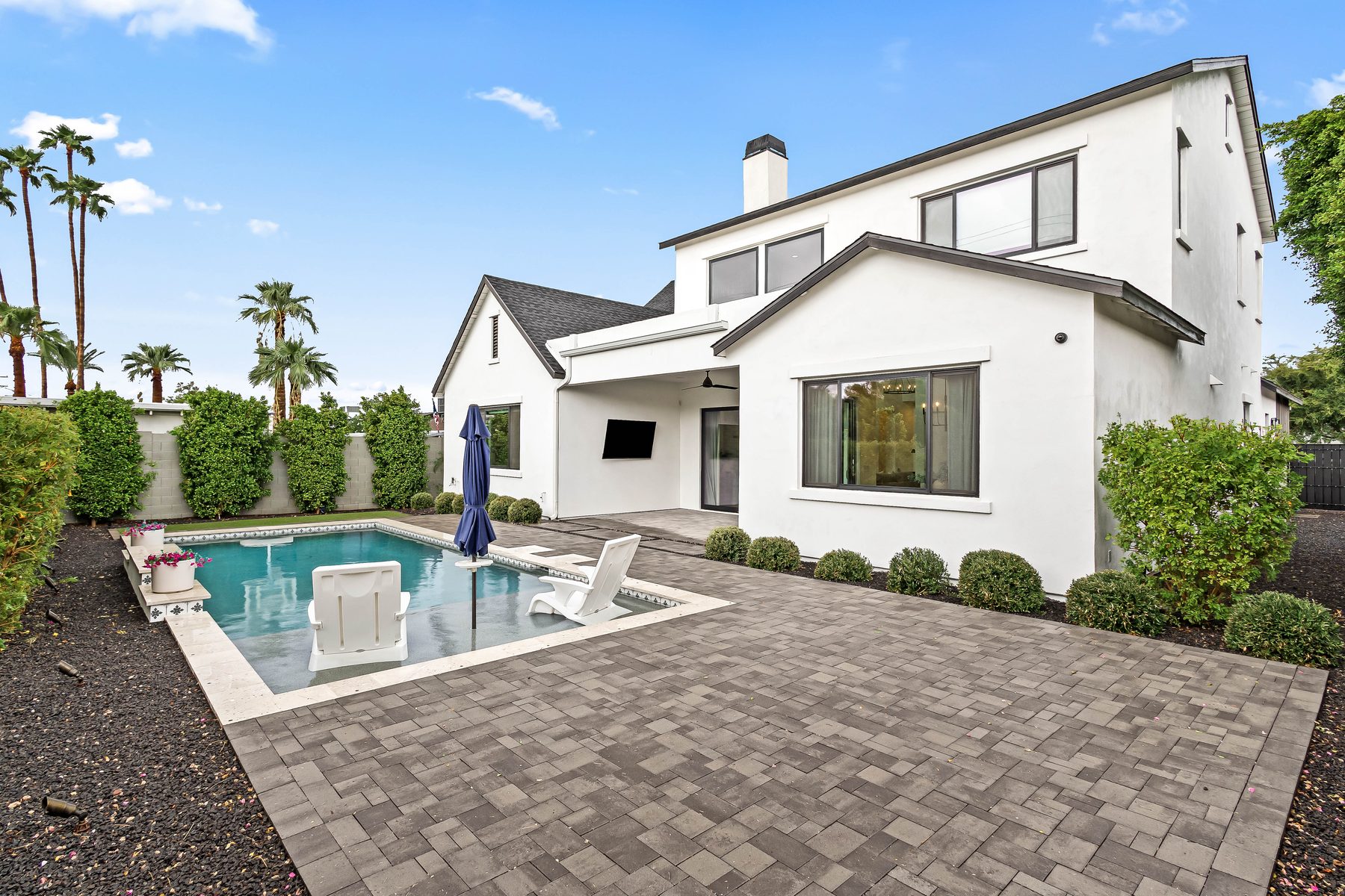 Backyard with pool, paver patio, and landscaping behind the home at 5513 E Verde Lane, Arcadia