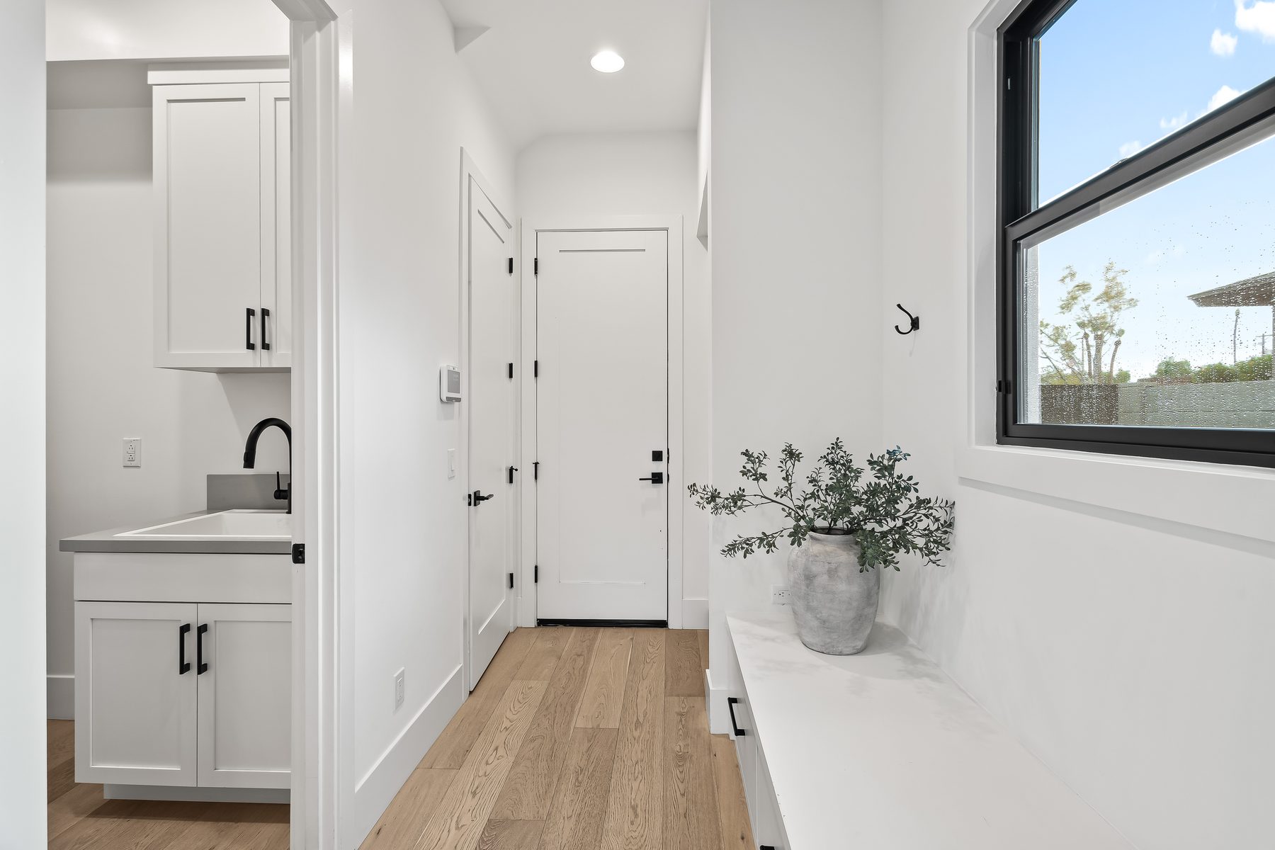 Hallway with cabinetry, a small sink, and a quartz counter at 5513 E Verde Lane