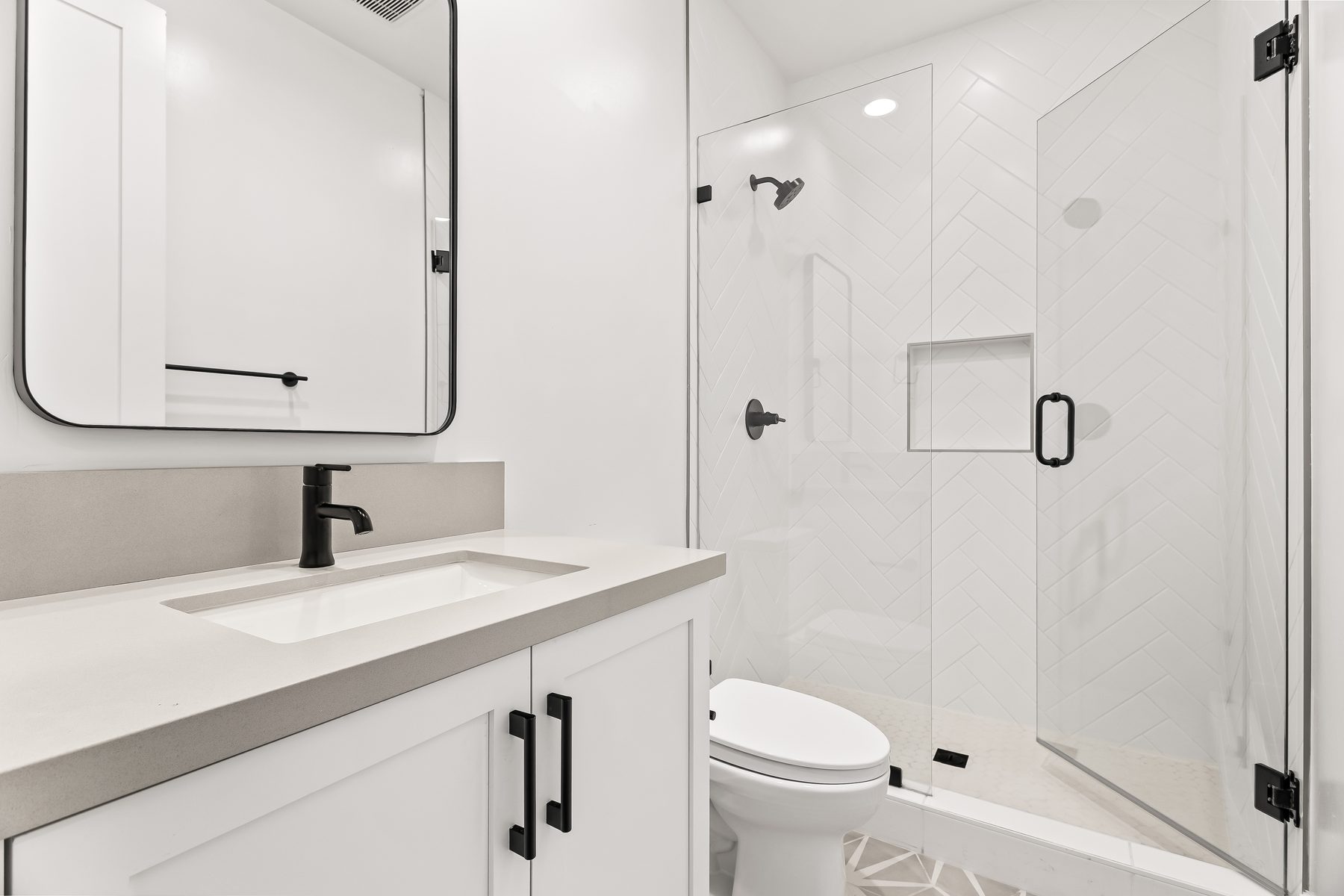 Secondary bathroom with quartz vanity and frameless glass shower at 5513 E Verde Lane