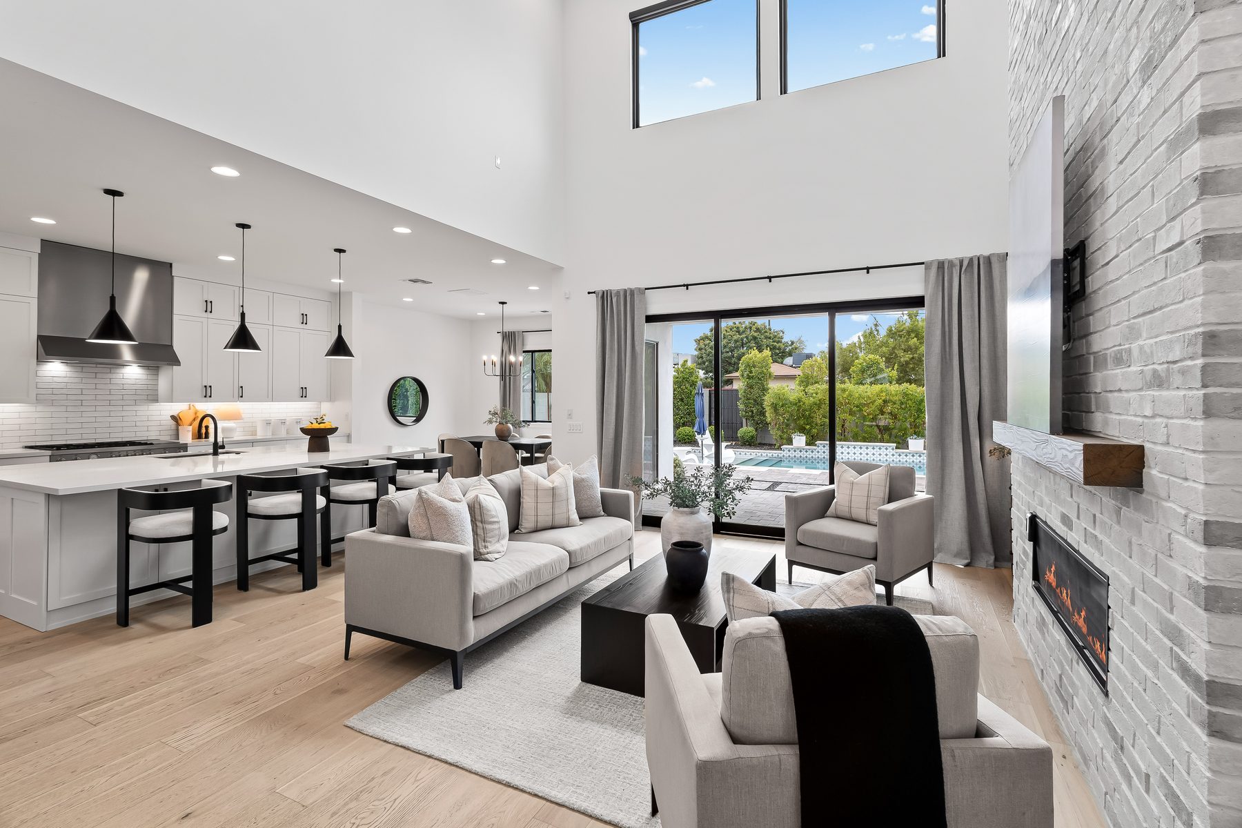 Great room with gas fireplace and seating, kitchen island in the background, 5513 E Verde Lane, Lower Arcadia